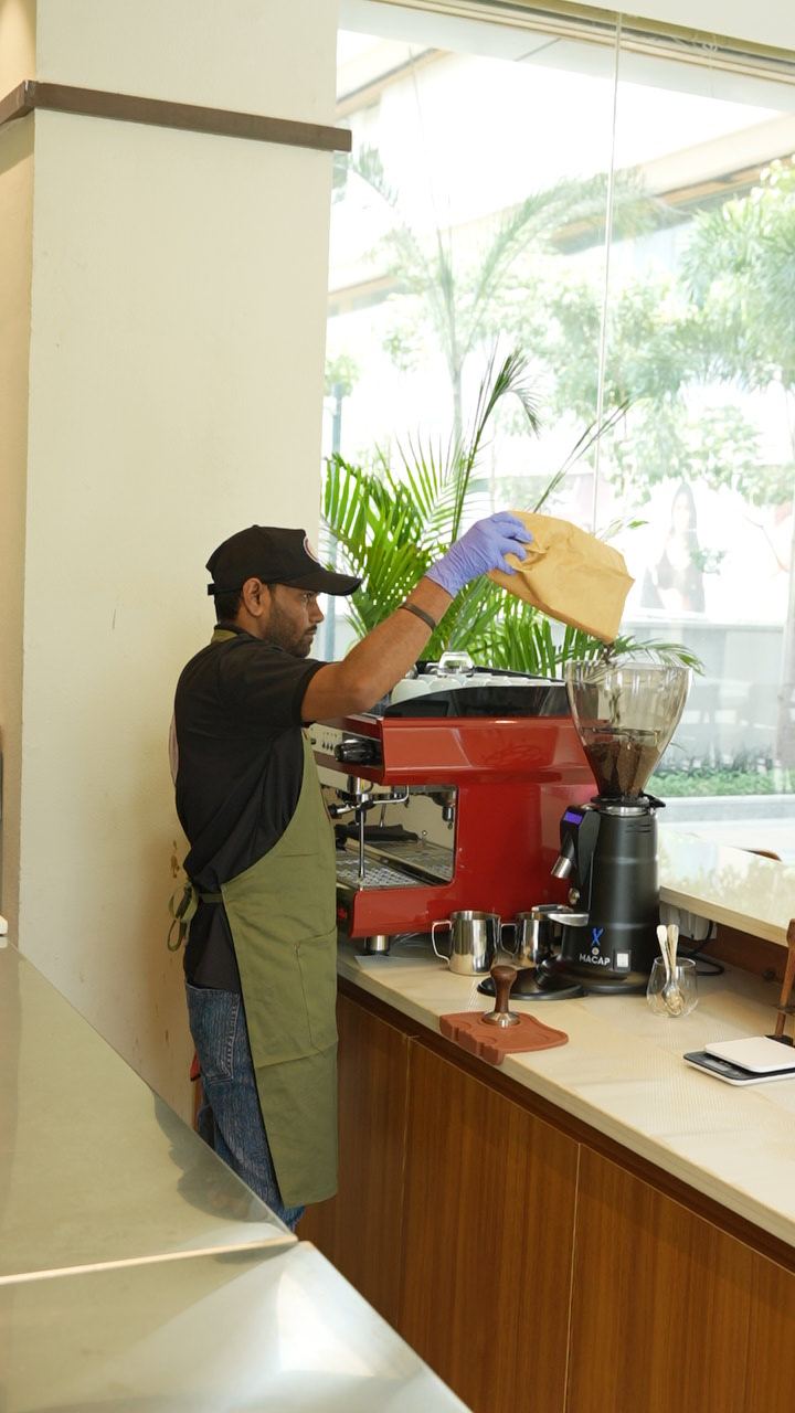 Our barista filling the grinder at the SABI espresso bar